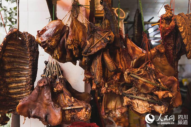 春節將近，成都市新開寺街，街邊肉鋪挂滿待出售的排骨、豬頭肉等臘味。實習生王文韜 攝