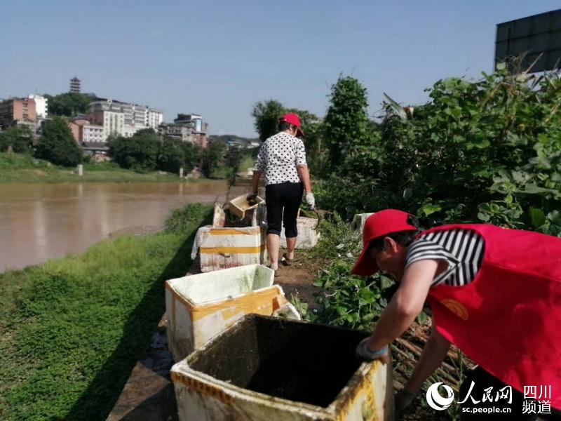 清理河道旁垃圾。恩陽區融媒體中心供圖