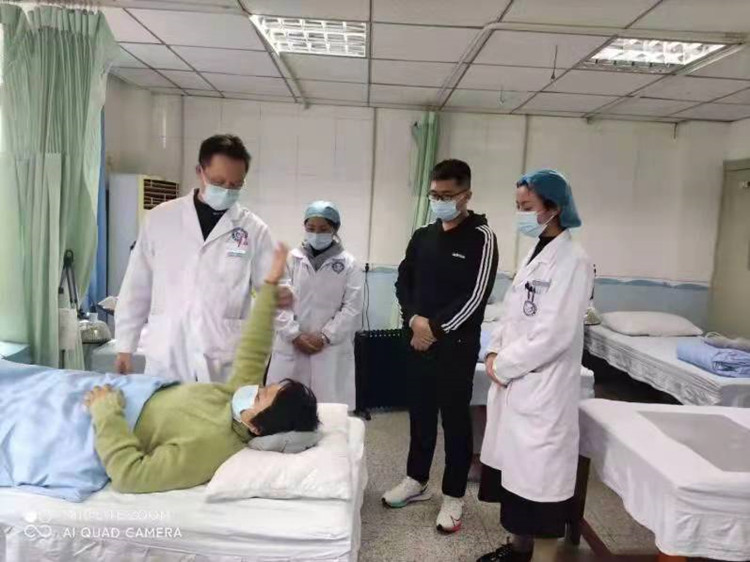 医生了解病人康复情况。绵竹市融媒体中心供图
