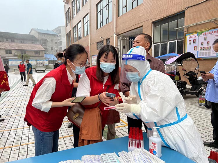 税务志愿服务队员服务核酸检测现场。达州市税务局供图