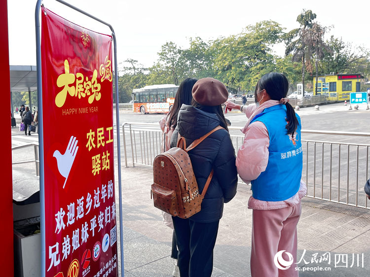 青年志愿者为回乡人员服务。叶昌荣摄