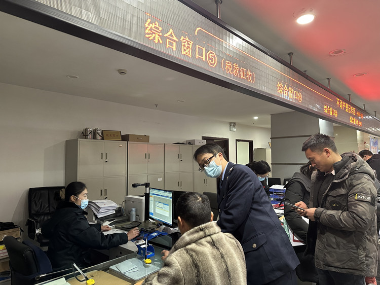 税务干部在税务大厅辅导纳税人办理业务。达州市税务局供图