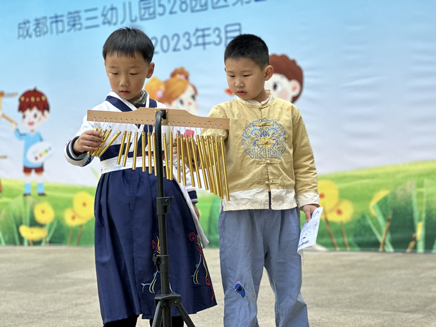 孩子正在舞台上进行乐器表演。成都市第三幼儿园528园区供图