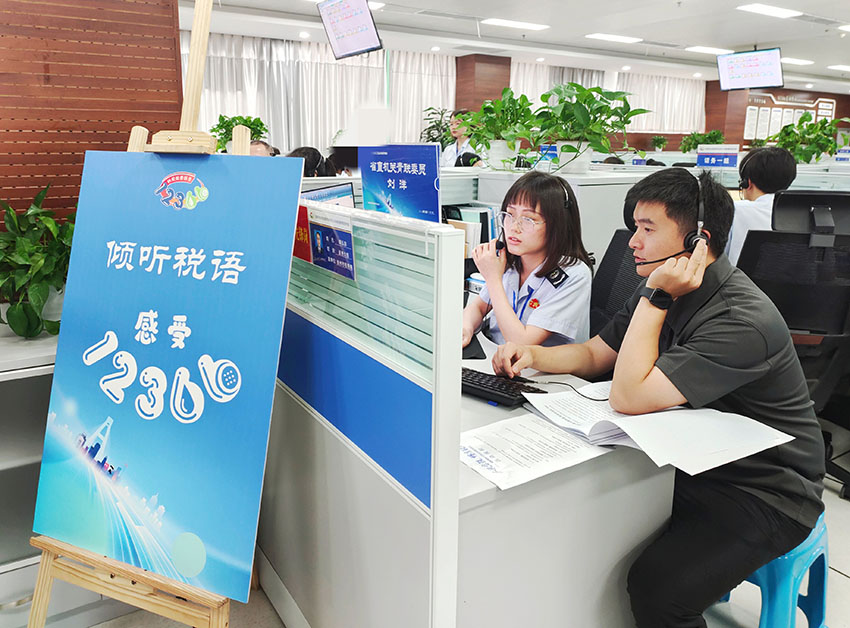 参观代表体验接线员回答电话咨询。四川省税务局供图
