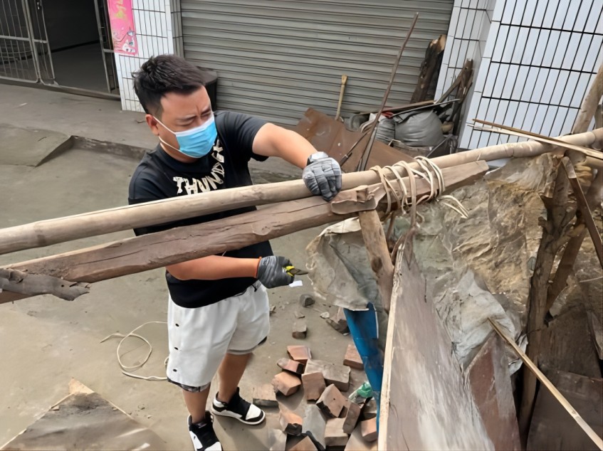 “第一书记”韦浩拆除简易棚。谢娇供图