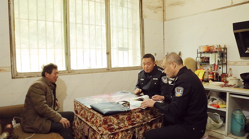 项目警官走访固军水库项目周边住户。万源市融媒体中心供图