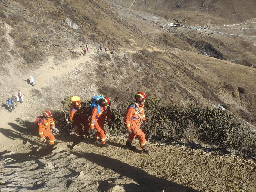 消防救援人员携带救援装备及补给物资，徒步进山搜救被困人员。四川省消防救援总队供图