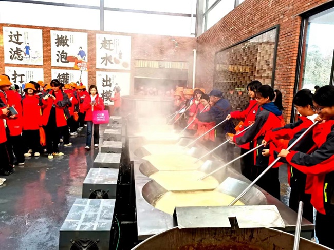 学生体验传统手工熬糖工艺。 四川汉安糖草农业科技有限公司供图