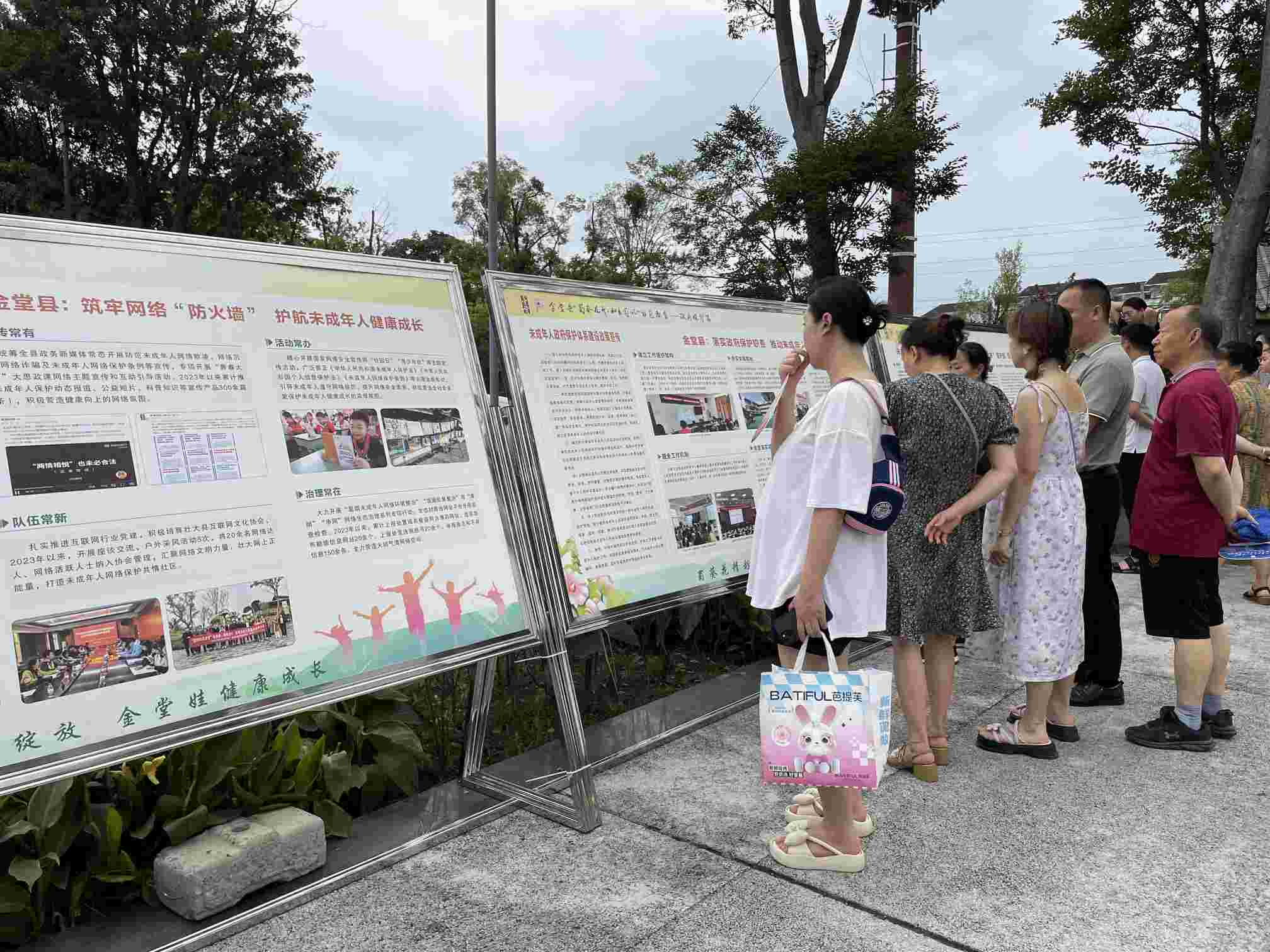 居民们阅读文明展板。金堂县委宣传部供图