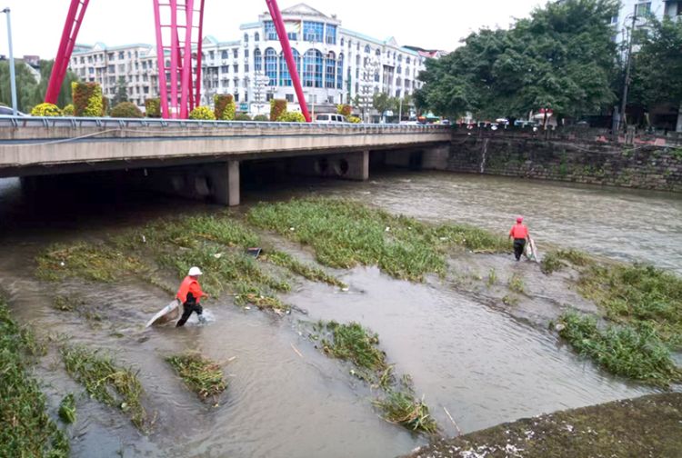 党员干部带头在河道里清理垃圾。绵竹市融媒体中心供图