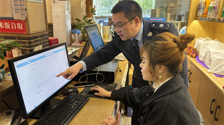 税务工作人员辅导宣汉丁格格餐饮店开具电子发票。宣汉县税务局供图