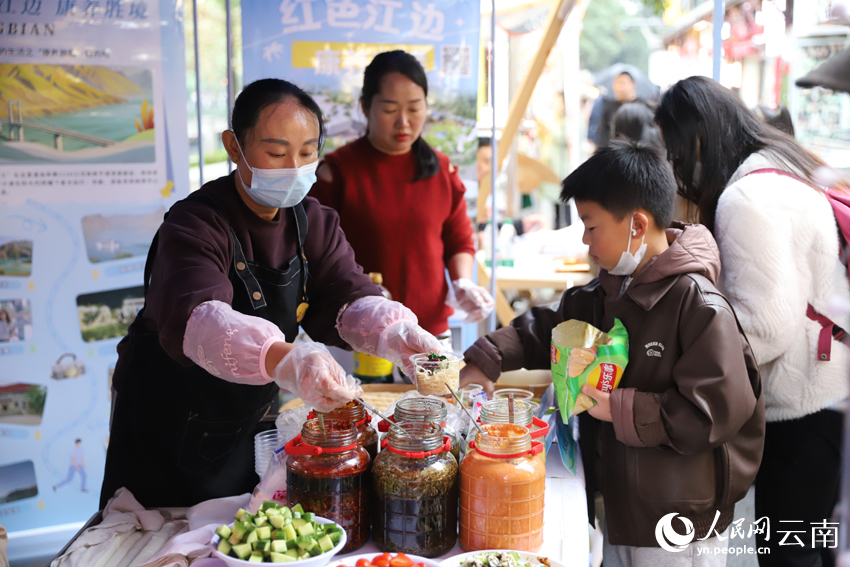 5一名小朋友在品尝元谋美食。人民网记者-李发兴摄.jpg