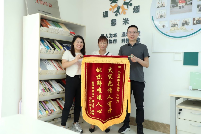 韩万秀向米易县局（分公司）赠送锦旗。攀枝花市烟草专卖局供图