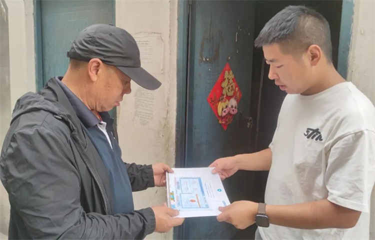 快递人员将异地办理的“文件”送到用户手中。黑水县融媒体中心供图