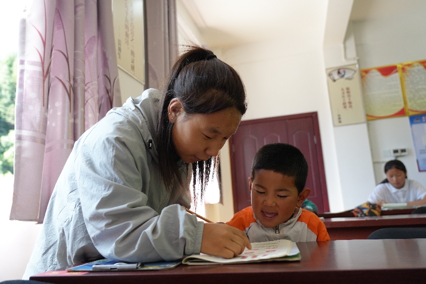 老師給孩子輔導作業。道孚縣委宣傳部供圖