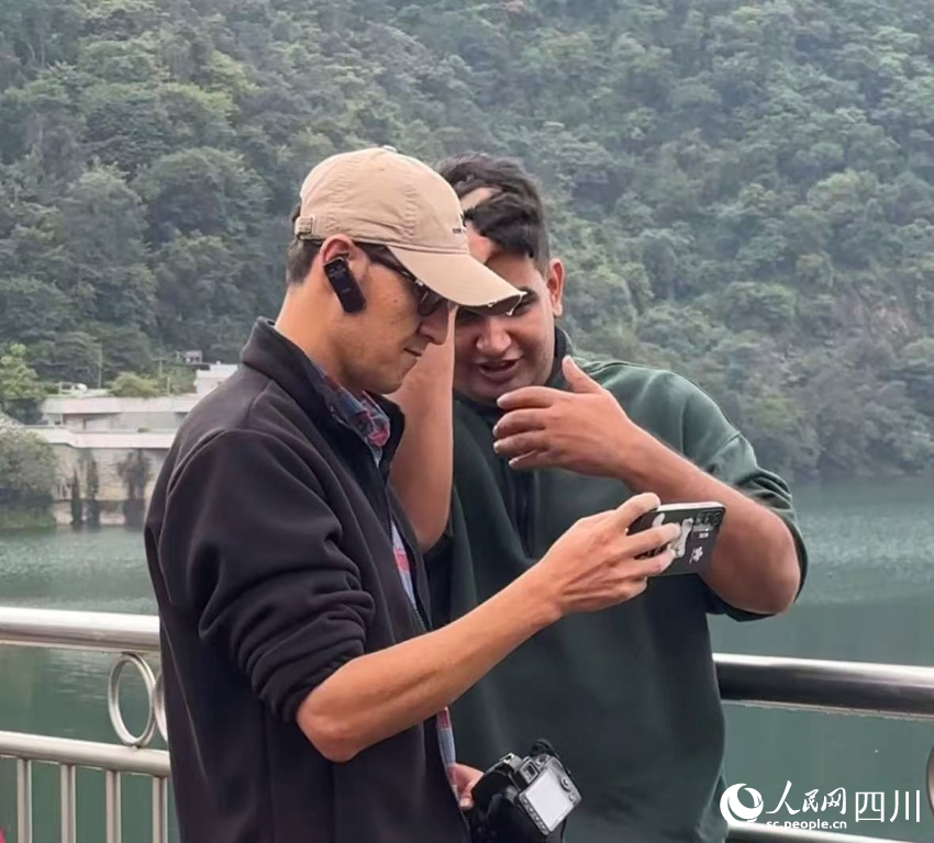 隨機組成的“拍照搭子”在探討照片。實習生 張雨欣攝