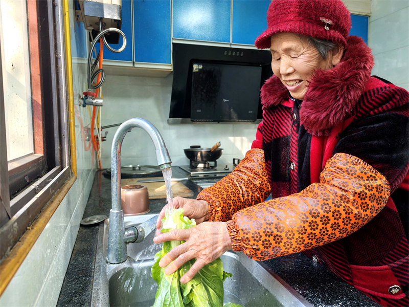 一位偏遠的農村老人正在用自來水洗菜。廣元市融媒體中心供圖