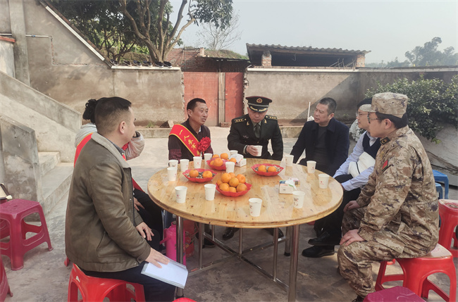 与军属交谈。沿滩区退役军人事务局供图