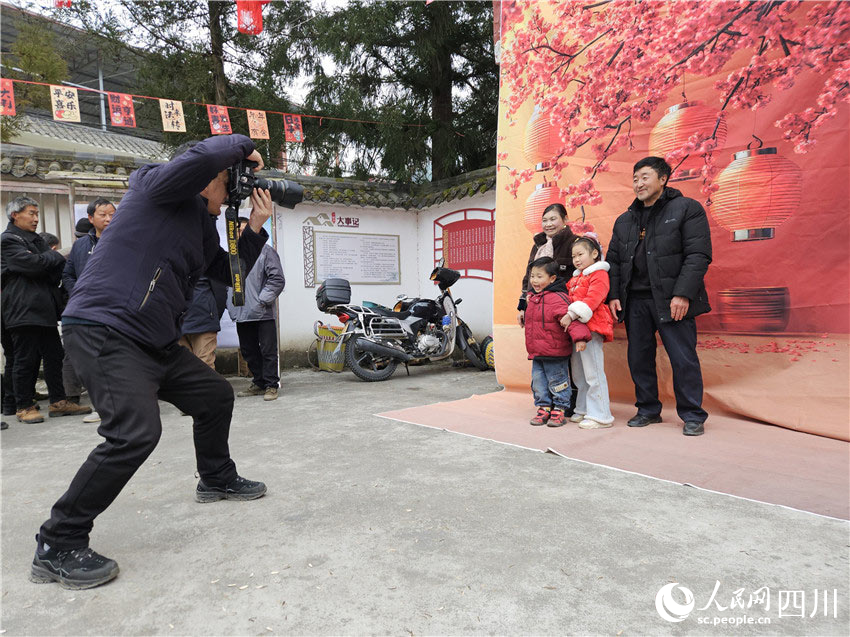 攝影師為村民們拍照。岳鵬攝