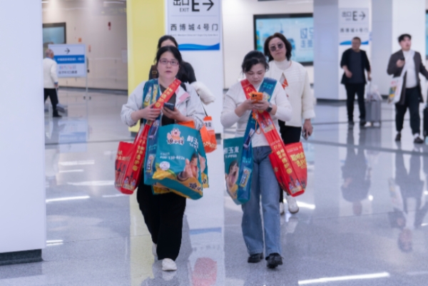 乘客携带糖酒会手提袋搭乘地铁。成都轨道集团供图