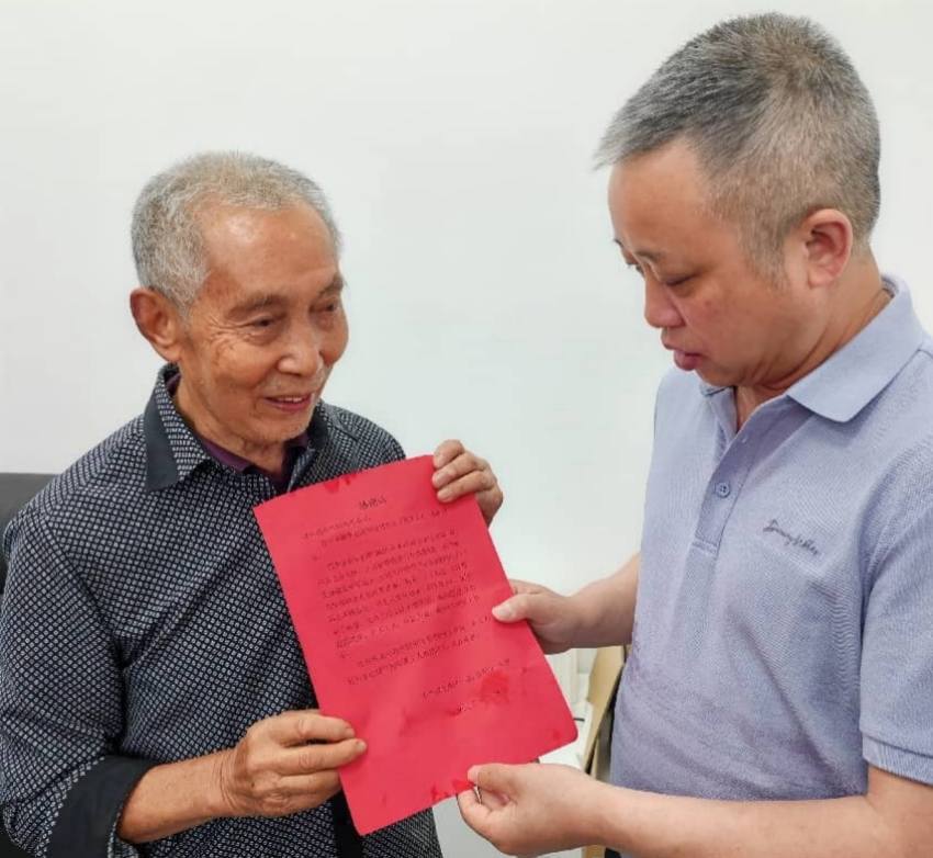 余仲谋（左）将感谢信送到有庆供电所党支部书记、所长王小伟（右）手中。四川省水电集团供图