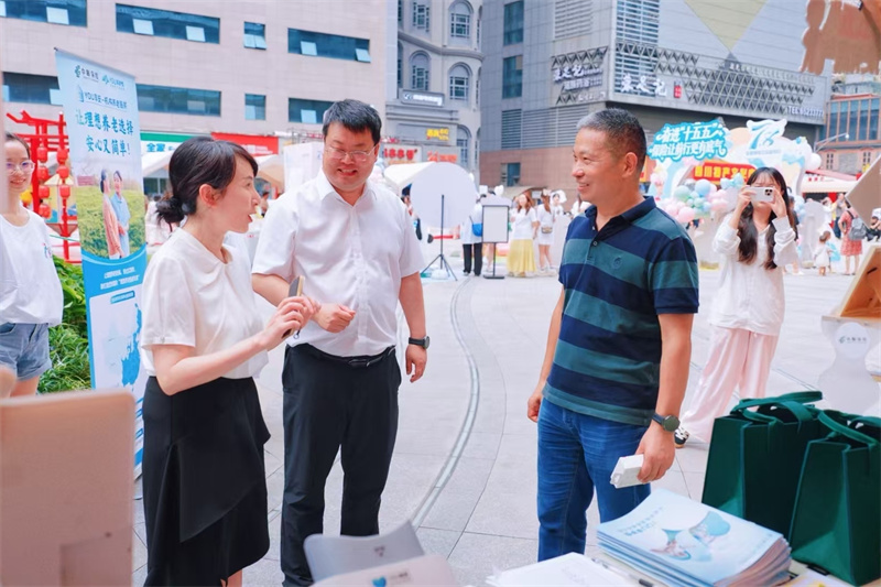 工作人员向市民介绍保险知识。中邮保险四川分公司供图