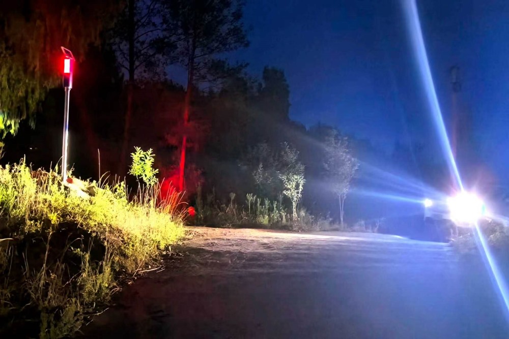 8月6日晚，通江县板桥口镇村道上，新安装的安全预警爆闪灯在夜色中发出醒目的红蓝交替光芒，为过往车辆提前示警。通江县委宣传部供图