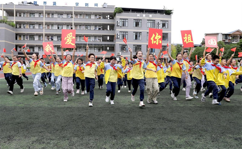 学生手舞国旗在校园开心奔跑。学校供图